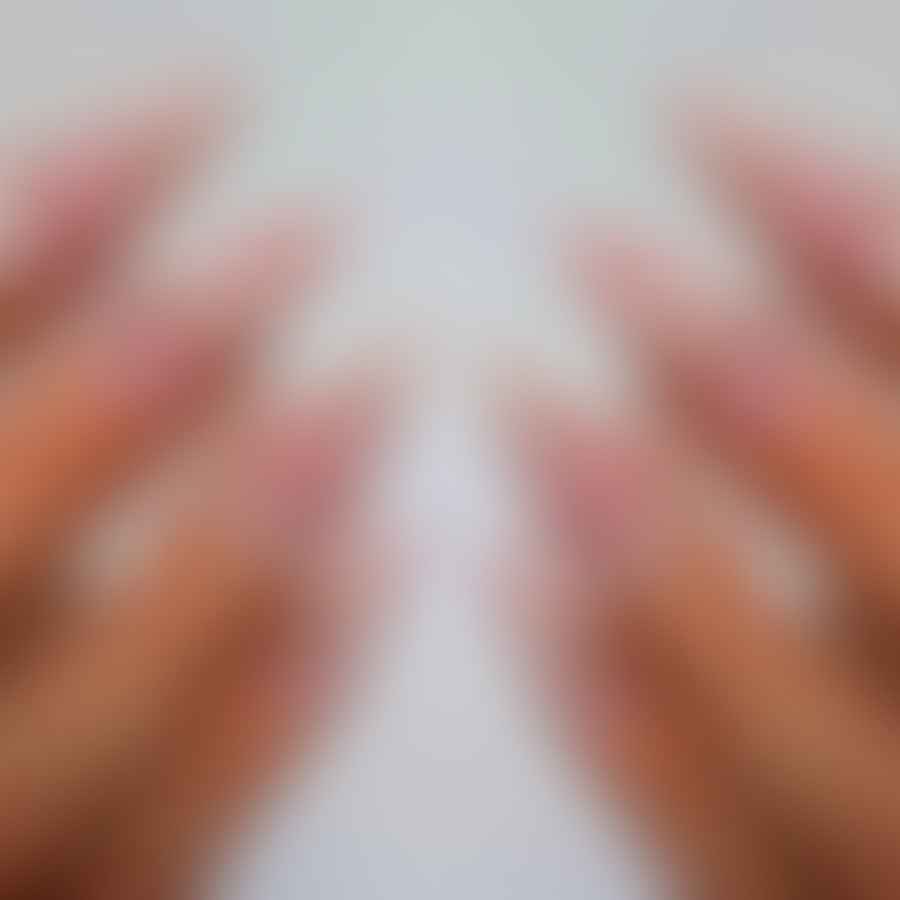 Elegant almond-shaped nails with nude polish and rhinestones design