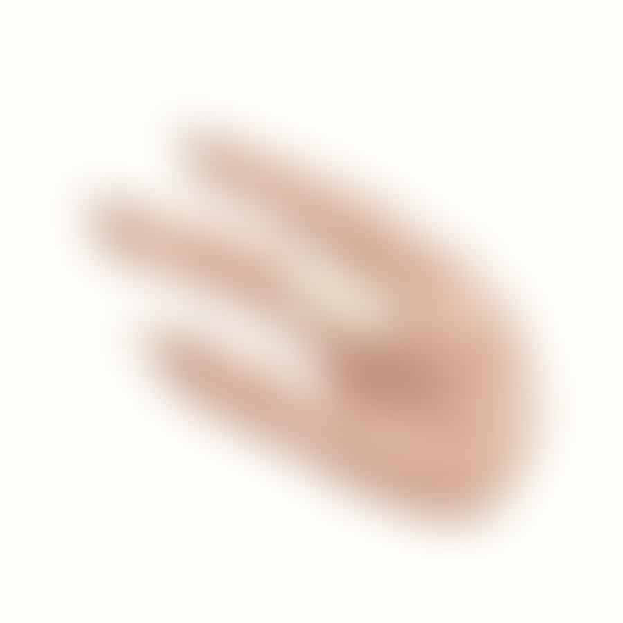A hand applying white nail polish to almond-shaped nails.