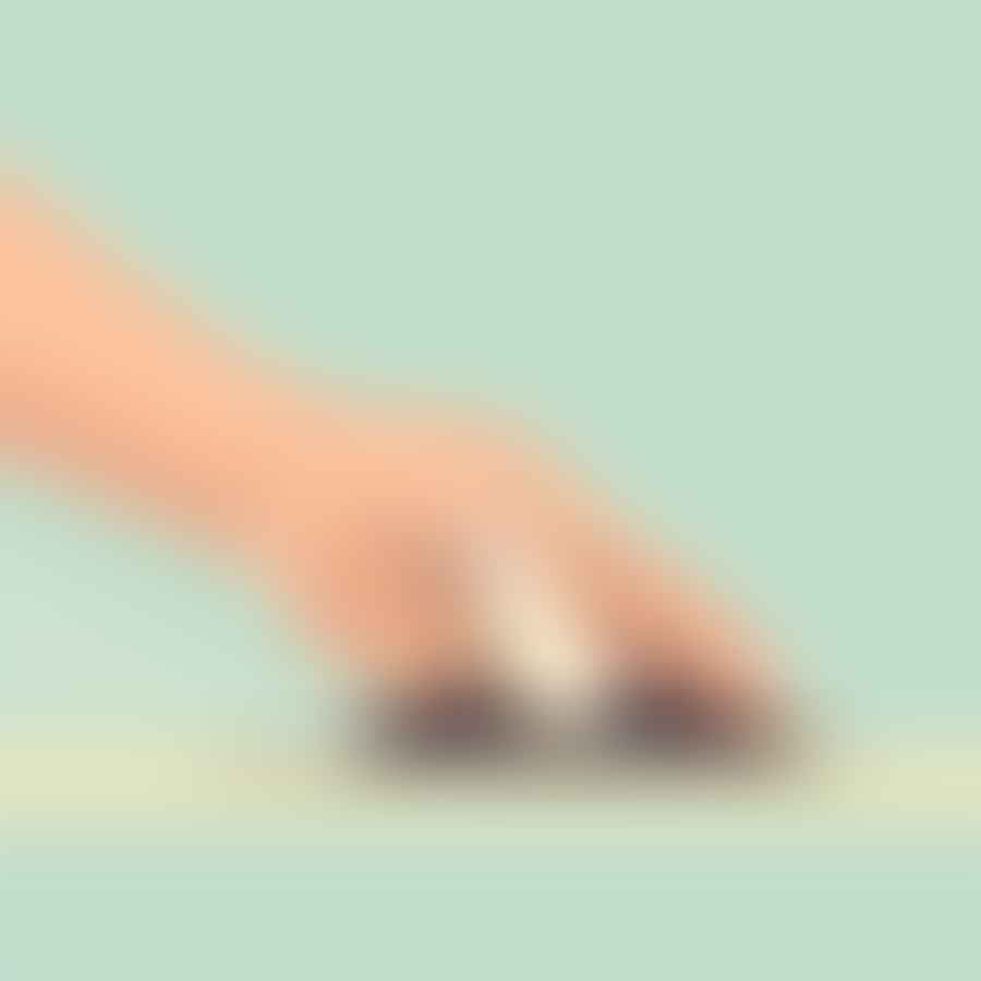 A hand using a toenail clipper to trim toenails.