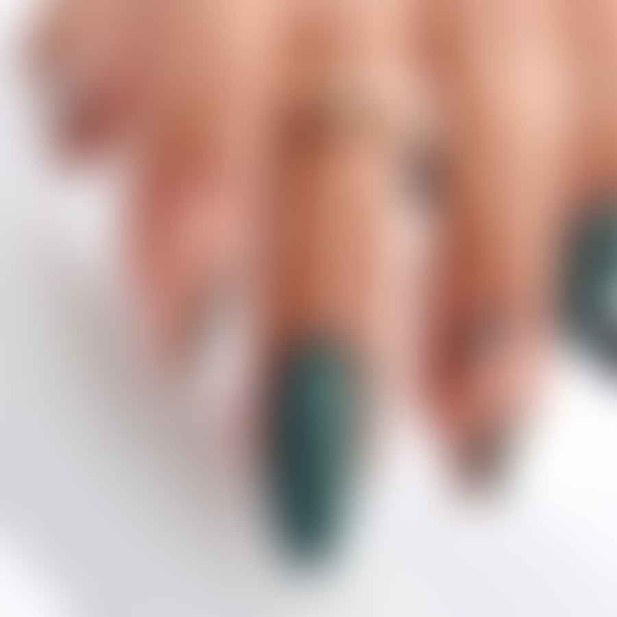 Woman showing off her stylish green almond-shaped nails