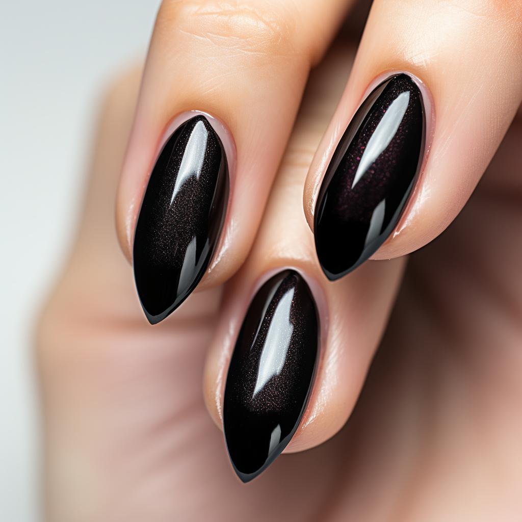 Almond-shaped nails painted with two coats of black nail polish.